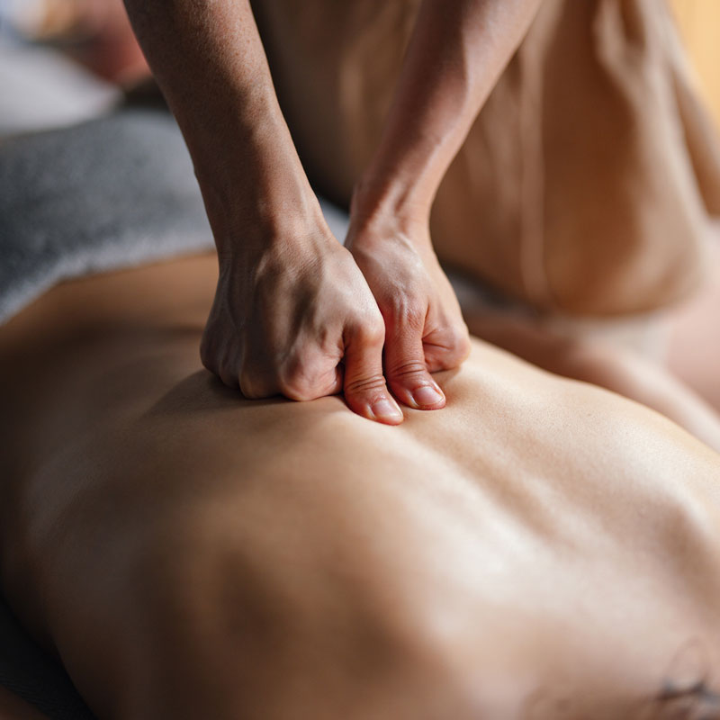 massage therapist massging client's back