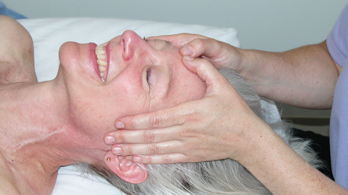 woman smiling receiving massage