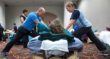 massage instructor demonstrating technique to student