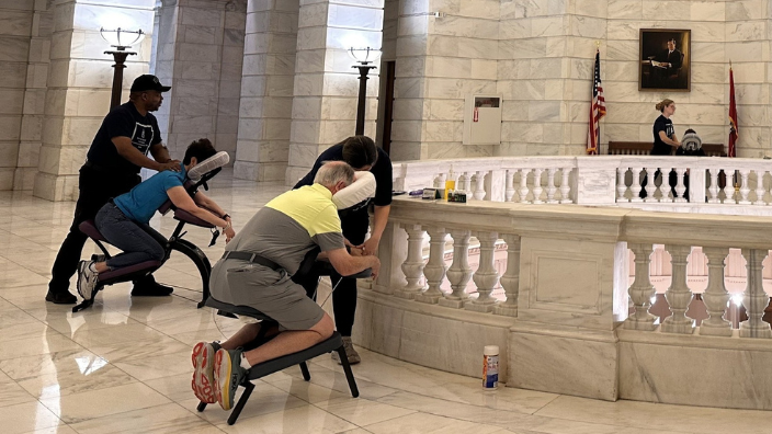 an image of people receiving chair massage in a government building.