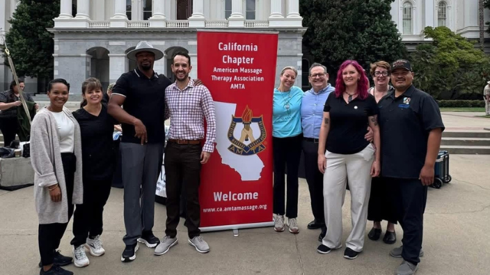 a group of people standing and smiling next to a "California advocacy days" sign.