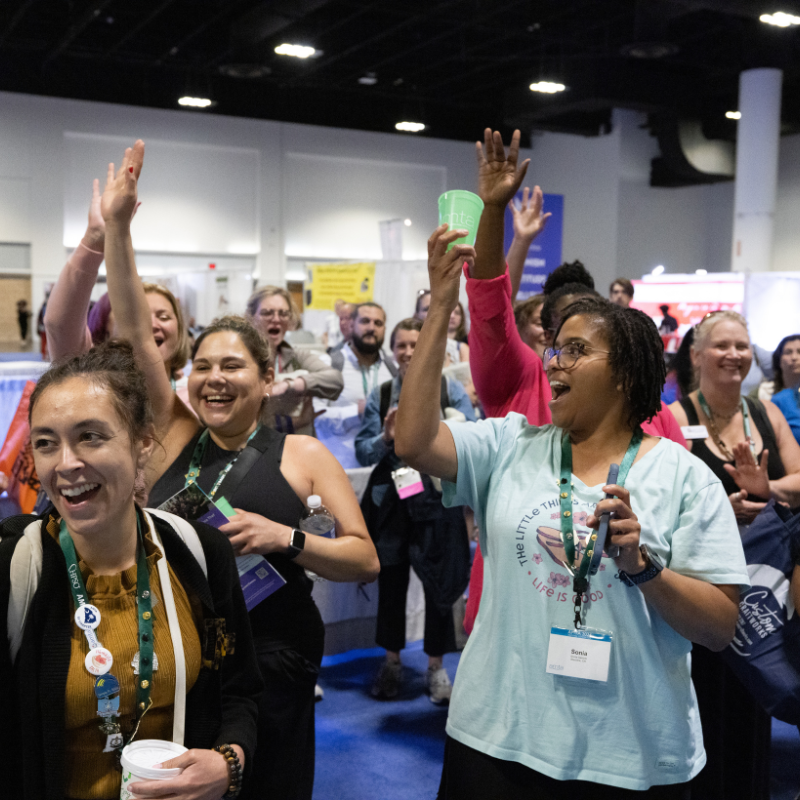 An image of a group of people who are cheering excitedly at AMTA's National Convention.