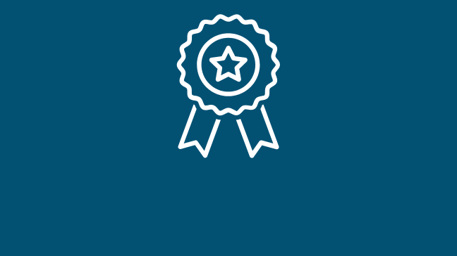 A graphic of a ribbon of achievement/award. The graphic is white against a navy background.