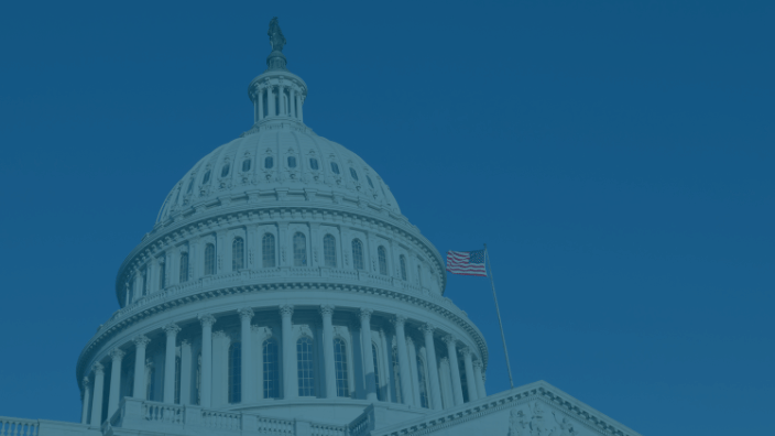 capitol building  with american flag flying next to it