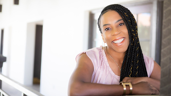 Headshot of Davonna Willis, a Black woman with long hair smiling