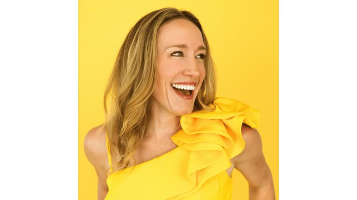 Image of Erin Stafford, woman in a yellow dress, smiling