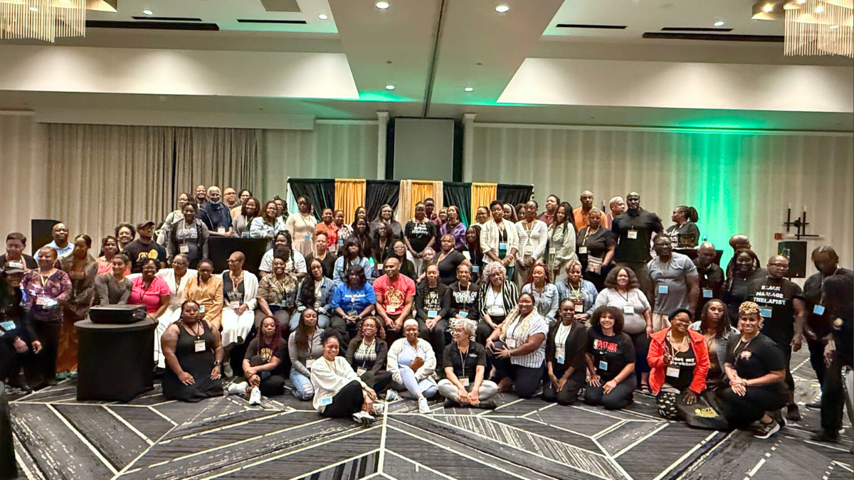 An image from the Black Massage Therapists Conference of a large group smiling.