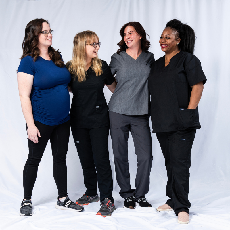 an image of a group of massage therapists standing together and smiling.