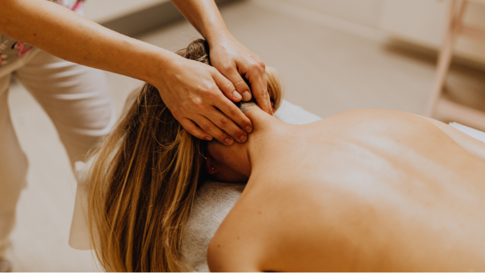 an image of a woman receiving a neck massage.