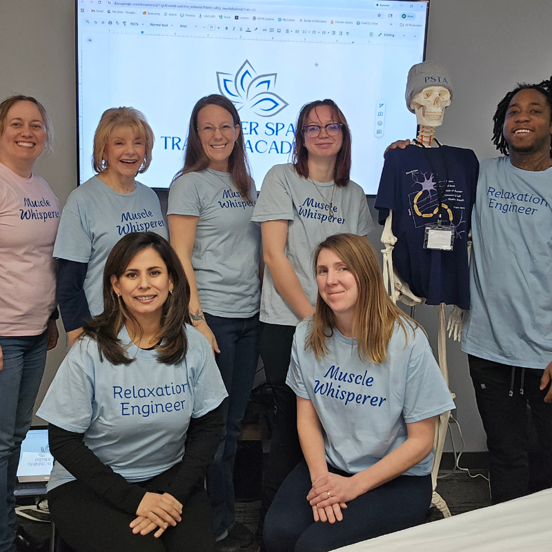 group of students posing next to an anatomy skeleton