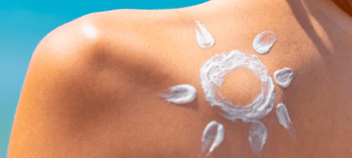 woman with sun on shoulder drawn with sunscreen