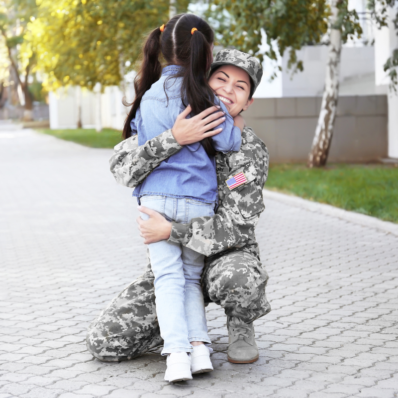an image of a female veteran hugging her child.